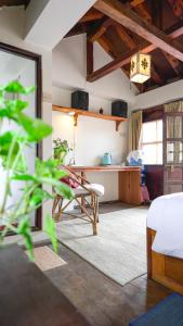 a living room with a bed and a desk at PatanGhar Homestay in Pātan +37 photos