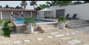 a house with a swimming pool and some plants at Hotel villa J Leticia in Cereté