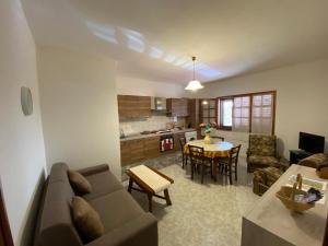 a living room with a couch and a table at CASA SANT'ANNA in SantʼAnna Arresi +19 photos