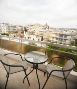a table and two chairs on a balcony with a view at Chrysa in Alexandroupoli