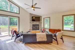 a living room with a couch and a fireplace at Pool and Beach Access Charming Poconos Cabin! in Albrightsville
