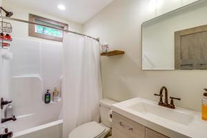 a bathroom with a sink and a toilet and a mirror at Pool and Beach Access Charming Poconos Cabin! in Albrightsville +27 photos