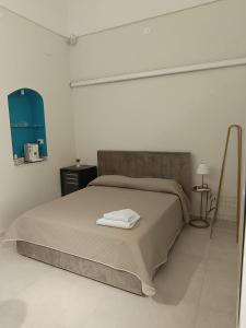 a bedroom with a bed with a towel on it at Historic House in Ercolano