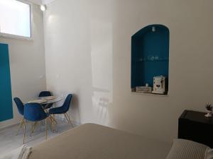a bedroom with a bed and a table and chairs at Historic House in Ercolano
