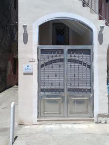 a garage door with a metal gate on a building at Historic House in Ercolano