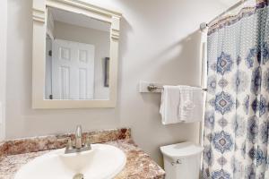 a bathroom with a sink and a mirror and a toilet at Pawleys Island #2 in Pawleys Island +48 photos