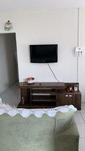 een woonkamer met een flatscreen-tv aan de muur bij Desativado in Petrolina