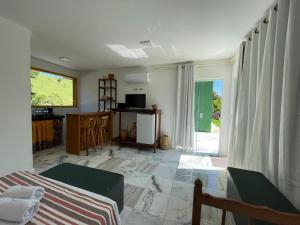 a room with a bed and a kitchen with a window at Chalés São João - a 500m da Cachoeira de Bom Jardim - com piscina in Mutum +48 photos