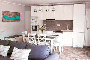 a kitchen and living room with a couch and a table at Mandula Villa in Tihany