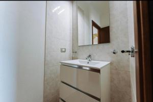 a bathroom with a sink and a mirror at Villetta Gio in Olìa Speciosa +20 photos