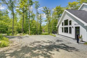 an empty driveway in front of a white building at Near Hiking Trails and Ski Resorts Killington Home! in Killington