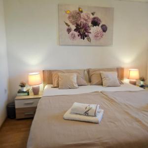 a bedroom with a bed with a towel on it at Apartment Viniška in Vinišće