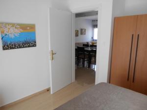 a bedroom with a door leading to a dining room at Pepi Cozy in Alexandroupoli +19 photos