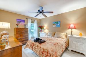 a bedroom with a bed and a ceiling fan at North Port Home with Charming Lanai about 7 Mi to Beach in North Port