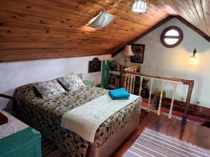a bedroom with a bed and a wooden ceiling at Casa d'Alegria Madeira Island in Ribeira Brava