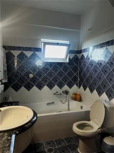 a bathroom with a tub and a toilet and a sink at Panoramic Elia Apartment in Míthoi +20 photos