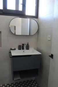 a bathroom with a white sink and a mirror at Honey Studio in Colmenar +19 photos