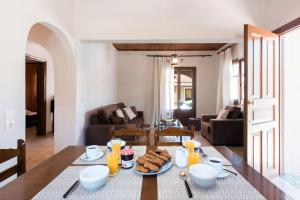 a table with a plate of food on it in a living room at Villa Stemal in Acharavi