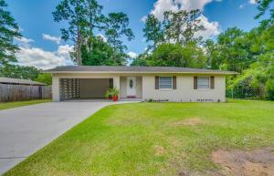 a small white house with a yard at Pet-Friendly Ocala Home with Pool and Fenced-In Yard! in Ocala