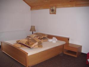 a bedroom with a bed with a wooden bed frame at Magdalenka - pokoje w centrum in Szczyrk