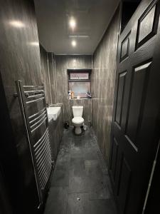 a small bathroom with a toilet and a sink at Cozy double near Train Station in Birmingham