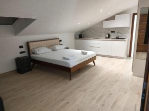 a large bedroom with a bed and a kitchen at APARTMANI CENTAR Selce in Selce