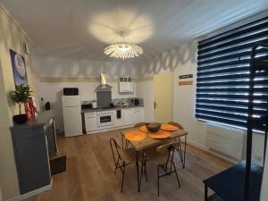 a kitchen and dining room with a table and chairs at City center Centre Ville, WIFI, 4 personnes Max in Épernay