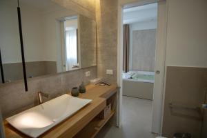 a bathroom with a sink and a mirror at B&B Le Muse in Mondello