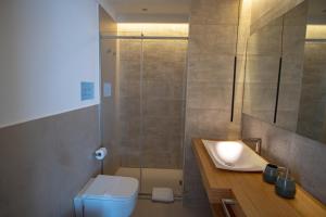 a bathroom with a shower and a toilet and a sink at B&B Le Muse in Mondello