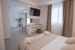 a white bedroom with a bed with towels on it at B&B Le Muse in Mondello