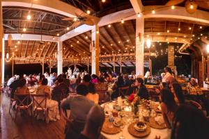 a group of people sitting at tables in a building at Ohana Villa, Tobago in Scarborough +57 photos