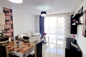 a living room with a couch and a table at FLH - Garden Grill Escape in Sibiu