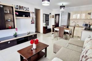 a living room with a couch and a table at FLH - Garden Grill Escape in Sibiu