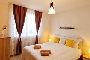 a bedroom with a bed with two towels on it at FLH - Garden Grill Escape in Sibiu