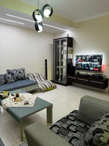 een woonkamer met een bank en een flatscreen-tv bij Brand New Apartament Durres in Durrës