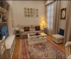 a living room with a couch and a table at Cozy LUXURY apartments*****. The city center in Valencia
