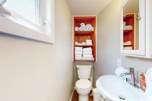 a bathroom with a toilet and a sink and a mirror at Gull's Getaway in York +25 photos