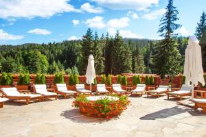 a park filled with lots of tables and chairs at Hotel Yastrebets Wellness & Spa in Borovets