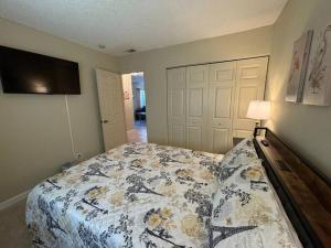 a bedroom with a bed with a quilt on it at Sea Breeze-2 BR Apartment- Centrally Located in West Palm Beach