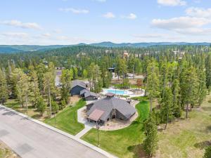 an aerial view of a house with a pool and trees at The Juniper - Hot tub in Lead