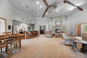 a large living room with a stone fireplace at The Juniper - Hot tub in Lead