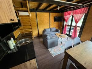 a living room with a couch and a table at Vikendica KaNo in Ždrijelo