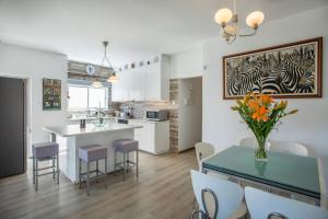 a kitchen and dining room with a table and chairs at Neapolis Residence Spacious Quiet Near beach in Limassol +24 photos