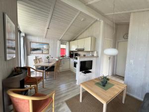 a kitchen and living room with a table and chairs at Strandpark 13 in Grömitz