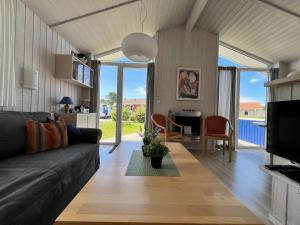 a living room with a couch and a table at Strandpark 13 in Grömitz