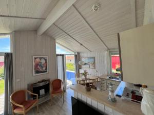 a kitchen with a table and chairs in a room at Strandpark 13 in Grömitz
