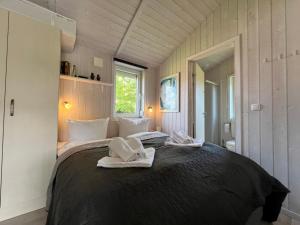 a bedroom with a bed with white shoes on it at Strandpark 13 in Grömitz +10 photos