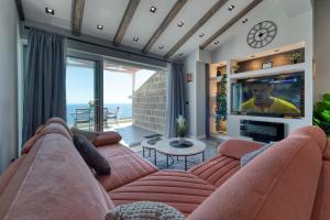 a living room with a couch and a tv at Villa Dommy Gabby in Dubrovnik