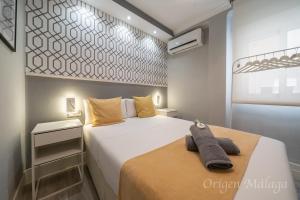 Postel nebo postele na pokoji v ubytování Xpce Malaga SOHO