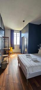 a bedroom with a bed and a blue wall at hotel terminus auray in Auray +9 photos
